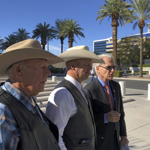 A federal appeals court has confirmed the dismissal of a criminal case against Nevada rancher Cliven Bundy (left), seen in 2018 with his son Ryan Bundy and attorney Larry Klayman. CREDIT: Ken Ritter/AP