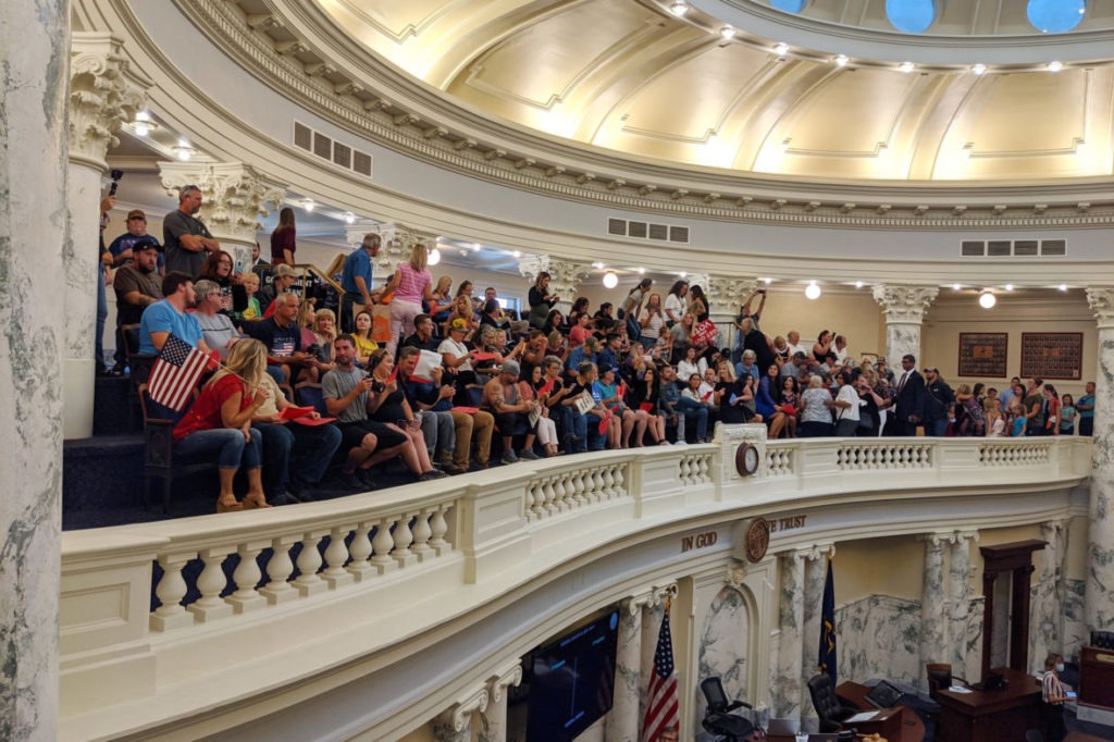 A large crowd of onlookers and protesters, most not wearing masks, some open carrying firearms, gathered in the Idaho Capitol in Boise for the state's special legislative session that began Monday, Aug. 24, 2020. CREDIT: Sami Edge/Idaho Education News