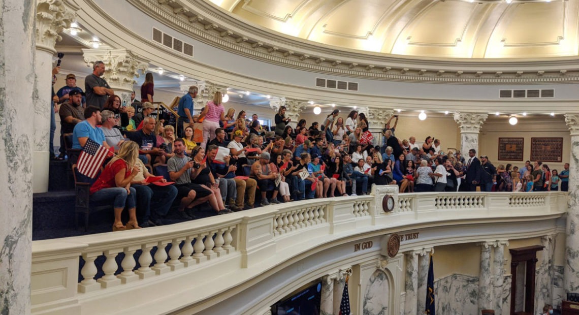 A large crowd of onlookers and protesters, most not wearing masks, some open carrying firearms, gathered in the Idaho Capitol in Boise for the state's special legislative session that began Monday, Aug. 24, 2020. CREDIT: Sami Edge/Idaho Education News