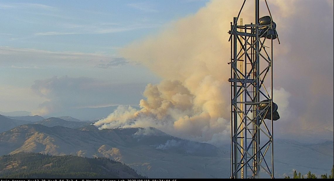 The Palmer Fire in Okanogan County, southwest of Oroville, seen from the Aeneas Mountain Lookout Tuesday evening, Aug. 18, 2020. Smoke from a fire in nearby British Columbia is also visible.