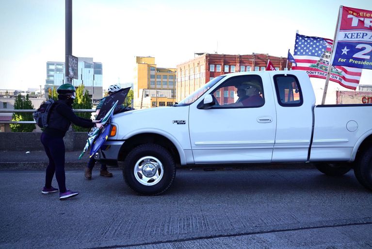 A man uses a truck to drive into and through anti-fascist counterprotesters at a pro-Trump caravan through Portland, Ore., Aug. 29, 2020. CREDIT: Jonathan Levinson / OPB