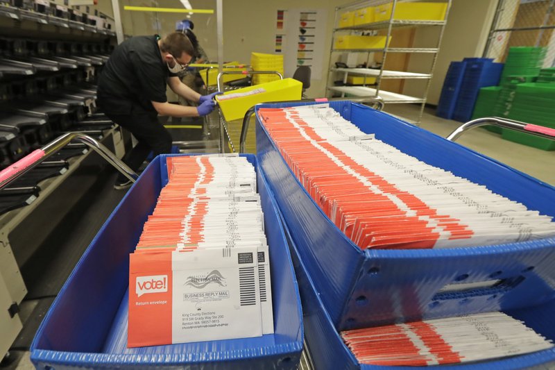 In this Aug. 5, 2020, vote-by-mail ballots are shown in sorting trays at the King County Elections headquarters in Renton, Wash. As of Tuesday, Aug. 11, 2020, nearly 53% of the ballots have been processed, with just over 53,000 remaining. CREDIT: Ted S. Warren/AP