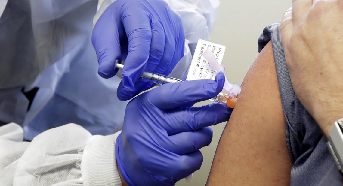 The second patient in a first-stage study of a potential vaccine for COVID-19 receives a shot in in March at the Kaiser Permanente Washington Health Research Institute in Seattle. CREDIT: Ted S. Warren/AP