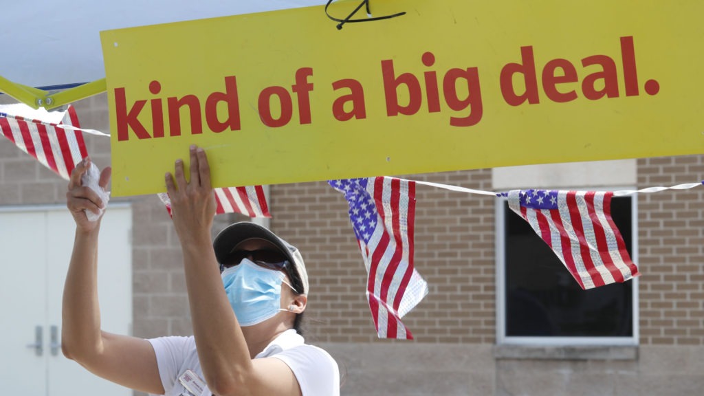 U.S. Census Bureau worker Marisela Gonzales adjusts a sign at a walk-up counting site for the 2020 census in Greenville, Texas, in July. CREDIT: LM Otero/AP