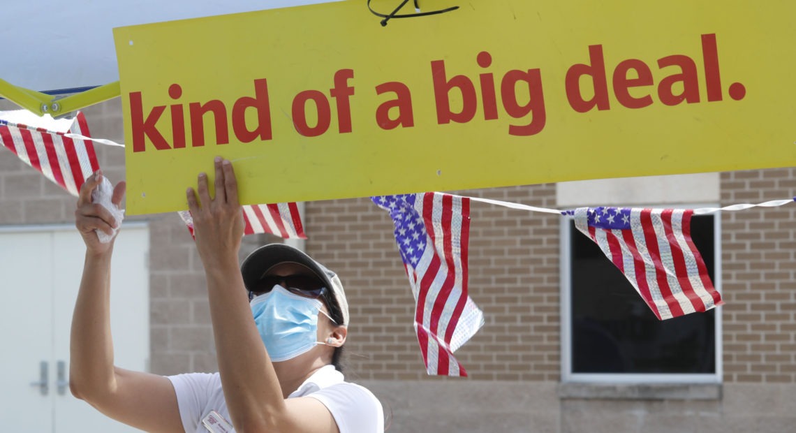 U.S. Census Bureau worker Marisela Gonzales adjusts a sign at a walk-up counting site for the 2020 census in Greenville, Texas, in July. CREDIT: LM Otero/AP