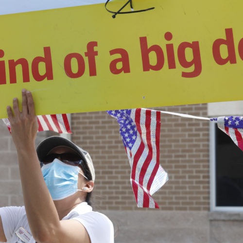 U.S. Census Bureau worker Marisela Gonzales adjusts a sign at a walk-up counting site for the 2020 census in Greenville, Texas, in July. CREDIT: LM Otero/AP