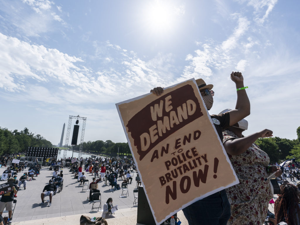 People attend the March on Washington, on Friday at the Lincoln Memorial in Washington, D.C., on the 57th anniversary of the Rev. Martin Luther King Jr.'s "I Have A Dream" speech. CREDIT: Alex Brandon/AP