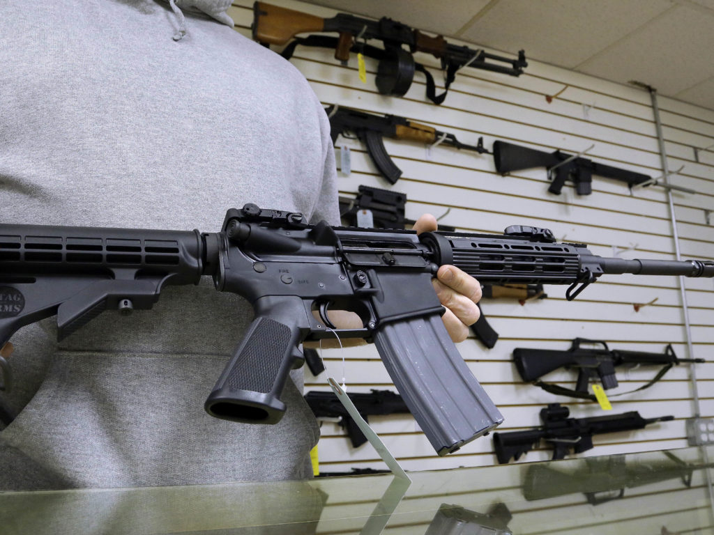 John Jackson, co-owner of Capitol City Arms Supply shows off an AR-15 assault rifle for sale Wednesday, Jan. 16, 2013 at his business in Springfield, Ill. President Barack Obama launched the most sweeping effort to curb U.S. gun violence in nearly two decades, announcing a $500 million package that sets up a fight with Congress over bans on military-style assault weapons and high-capacity ammunition magazines just a month after a shooting in Connecticut killed 20 school children. CREDIT: Seth Perlman/AP