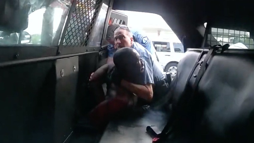 Minneapolis officer Derek Chauvin is seen struggling to force George Floyd into the back seat of a police SUV, in newly released body camera video recorded by officer Tou Thao. Both Chauvin and Thao were fired, along with two other officers involved in Floyd's death on Memorial Day. All four former officers are facing charges. Hennepin County/MPR/YouTube/Screenshot by NPR