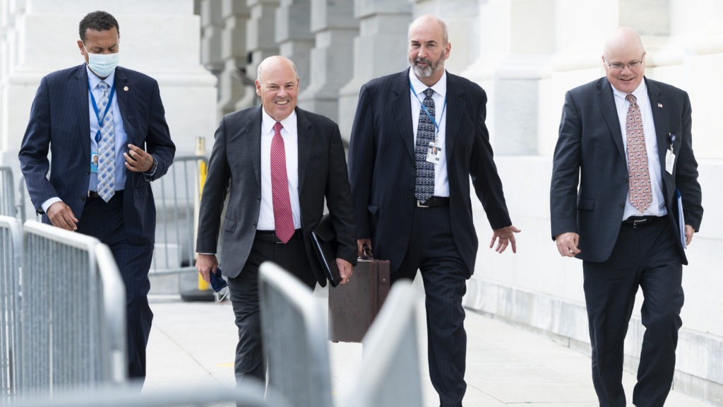 Postmaster General Louis DeJoy, second from left, leaves the U.S. Capitol after meeting Wednesday with Democratic leaders. Bill Clark/CQ Roll Call via Getty Images