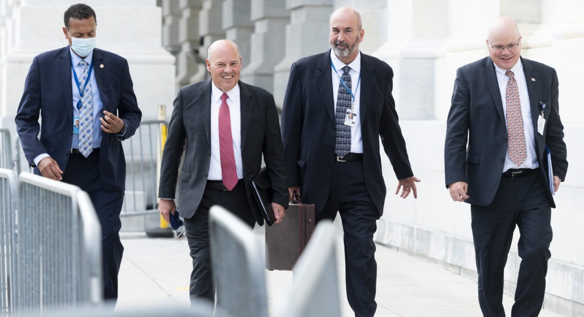 Postmaster General Louis DeJoy, second from left, leaves the U.S. Capitol after meeting Wednesday with Democratic leaders. Bill Clark/CQ Roll Call via Getty Images