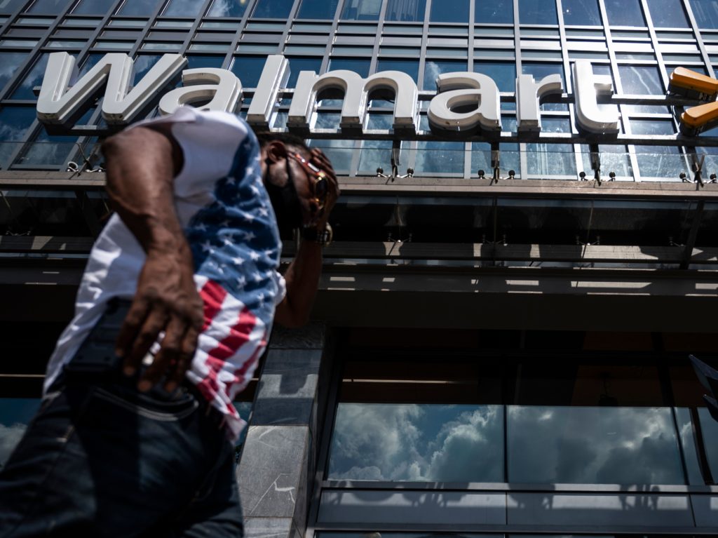 A man walks past a Walmart store in Washington, D.C. on July 15. Walmart said it was "confident" that its joint deal with Microsoft would satisfy both TikTok users and U.S. government regulators. CREDIT: Andrew Caballero-Reynolds/AFP via Getty Images