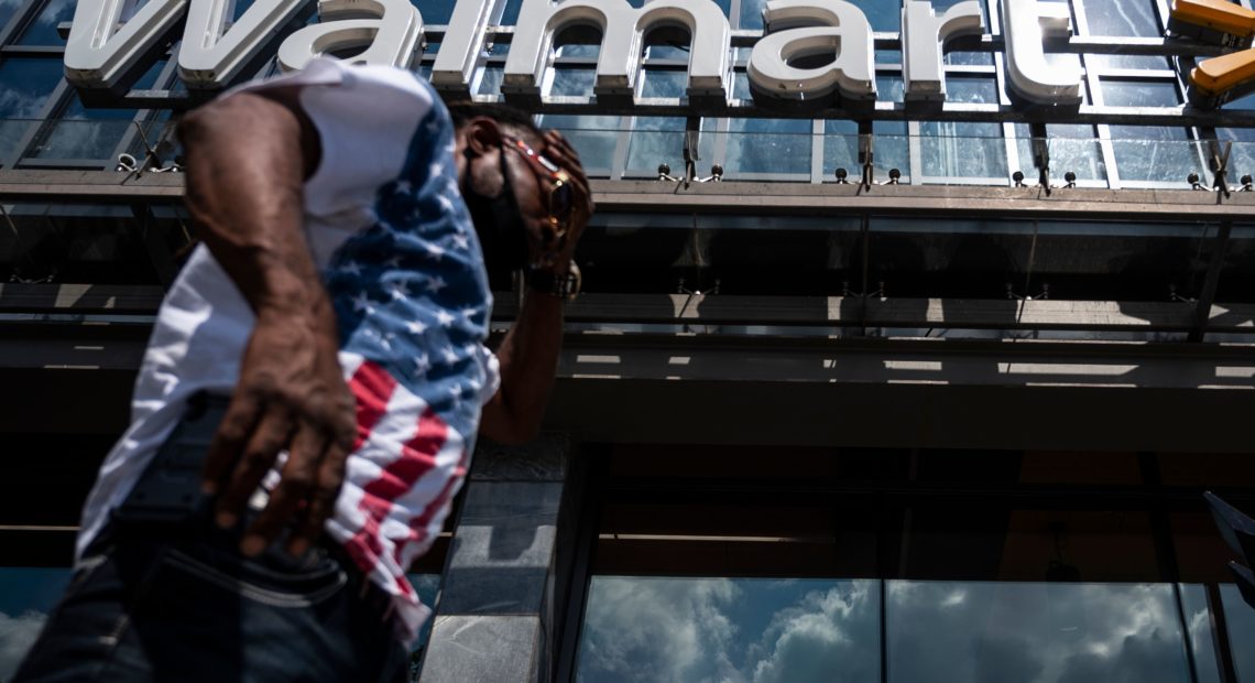 A man walks past a Walmart store in Washington, D.C. on July 15. Walmart said it was "confident" that its joint deal with Microsoft would satisfy both TikTok users and U.S. government regulators. CREDIT: Andrew Caballero-Reynolds/AFP via Getty Images