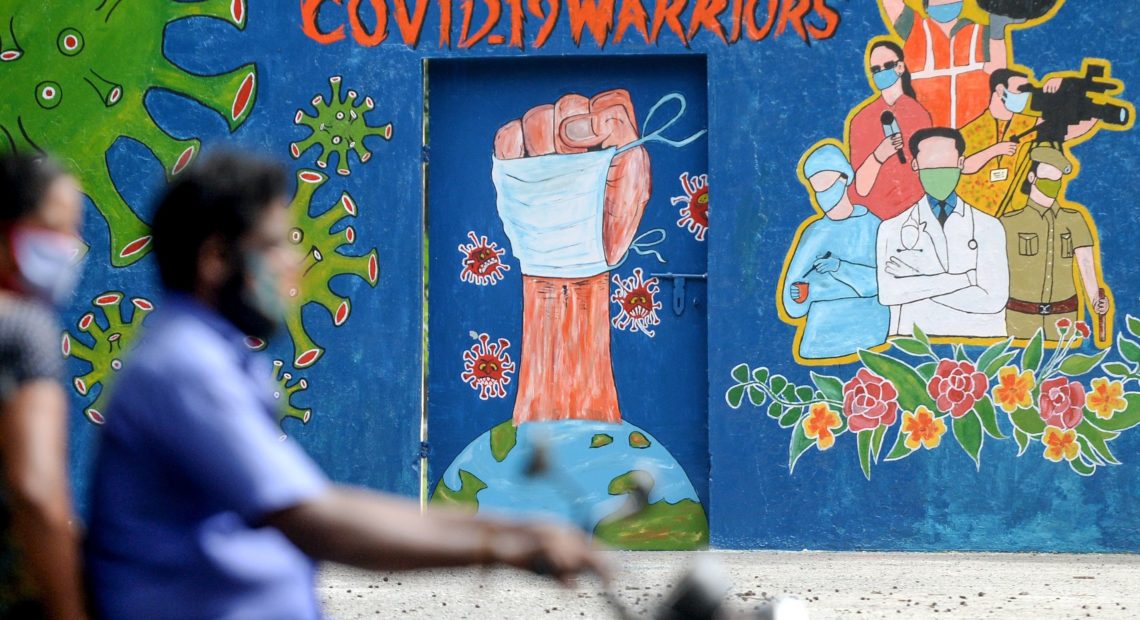A mural in Chennai, India, celebrates workers on the front lines against the coronavirus pandemic. The global case count crossed the 20 million threshold on Monday, with the U.S., Brazil and India in the lead. Arun Sankar/AFP via Getty Images