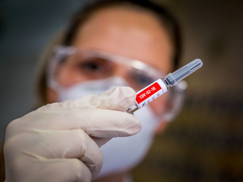 A nurse holds a COVID-19 vaccine candidate produced by Chinese company Sinovac Biotech at the São Lucas Hospital in Porto Alegre, Brazil, on Aug. 8. Silvio Avila/AFP via Getty Images