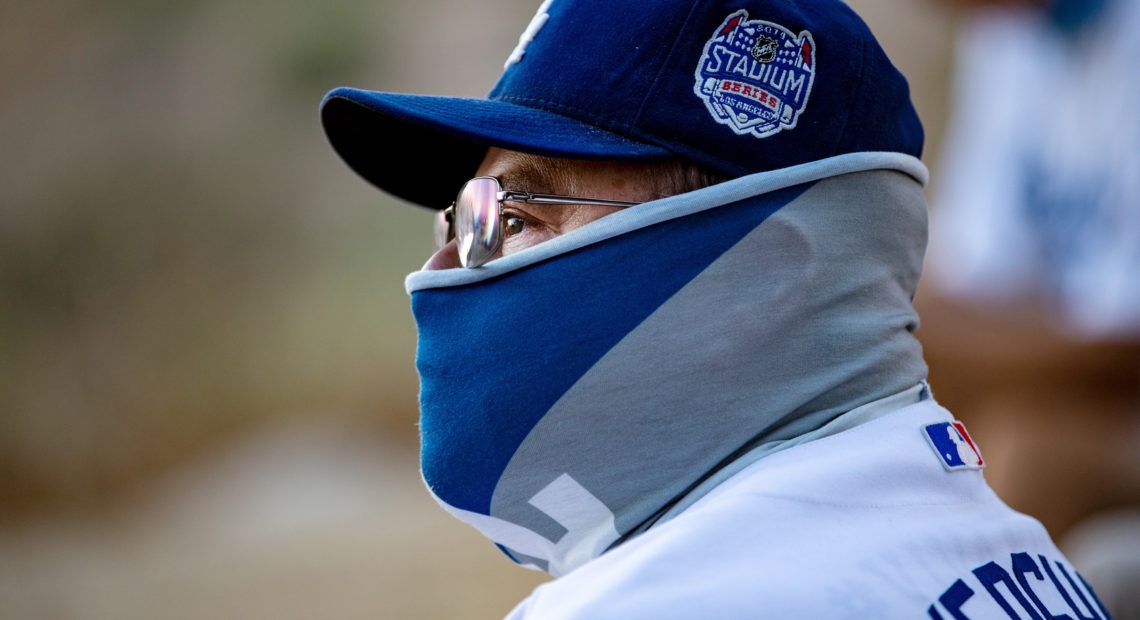 A fan wears a neck gaiter as he watches the Los Angeles Dodgers play at home against the San Francisco Giants last week. Gina Ferazzi/Los Angeles Times via Getty Images