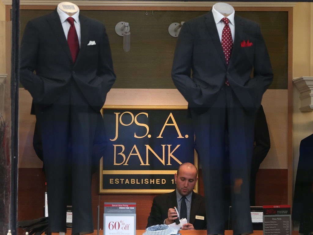 An employee works inside a Jos. A. Bank retail store in San Francisco. The parent company Tailored Brands earlier said it would close up to 500 stores and cut 20% of corporate jobs. CREDIT: Justin Sullivan/Getty Images