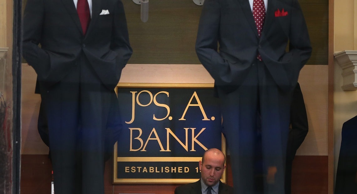 An employee works inside a Jos. A. Bank retail store in San Francisco. The parent company Tailored Brands earlier said it would close up to 500 stores and cut 20% of corporate jobs. CREDIT: Justin Sullivan/Getty Images