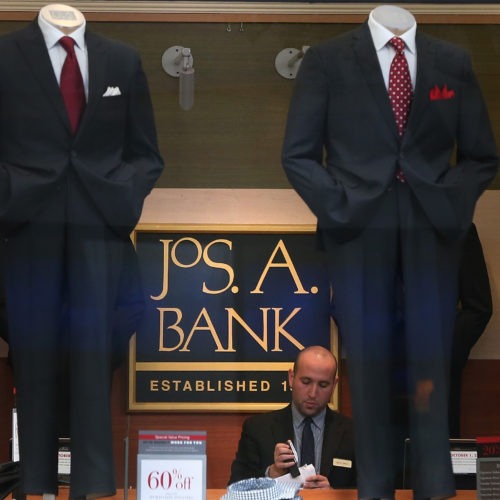 An employee works inside a Jos. A. Bank retail store in San Francisco. The parent company Tailored Brands earlier said it would close up to 500 stores and cut 20% of corporate jobs. CREDIT: Justin Sullivan/Getty Images
