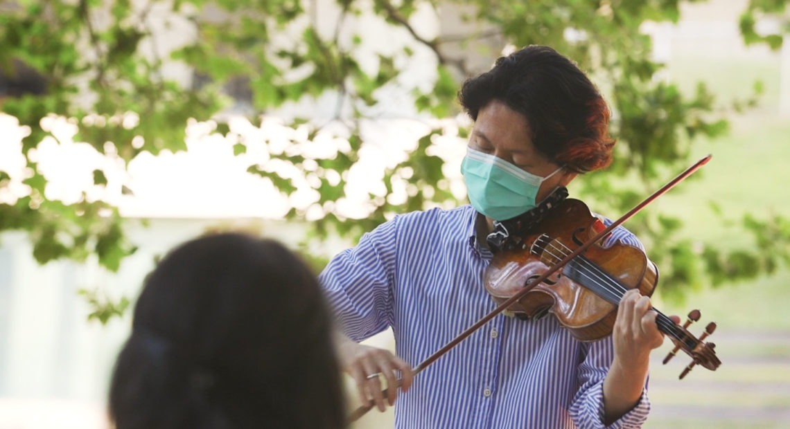 New York Philharmonic first violinist Kuan Cheng Lu, playing for a socially distanced audience of two at Lincoln Center on July 31. CREDIT: NPR Music/YouTube