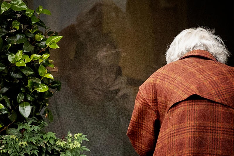 Dorothy Campbell talks to her husband, Gene Campbell, on the phone through his window at the Life Care Center of Kirkland on March 5, 2020, in Kirkland. CREDIT: Megan Farmer/KUOW