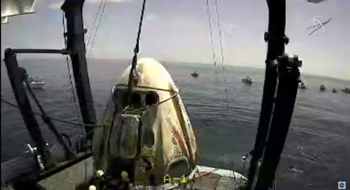 The SpaceX capsule sits aboard a recovery ship in the Gulf of Mexico. CREDIT: NASA/Screenshot by NPR