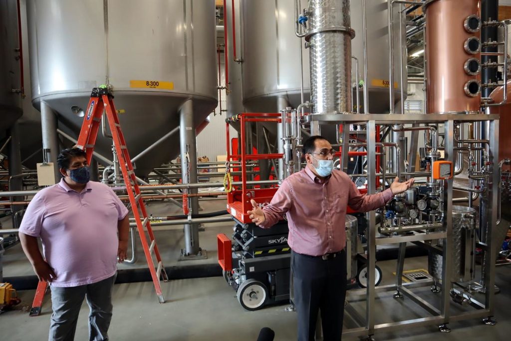 Chehalis tribal chairman Harry Pickernell, left, looks on as Chehalis Tribal Enterprises CEO David Burnett explained distillery operations during a tour in September 2020. CREDIT: Tom Banse/N3