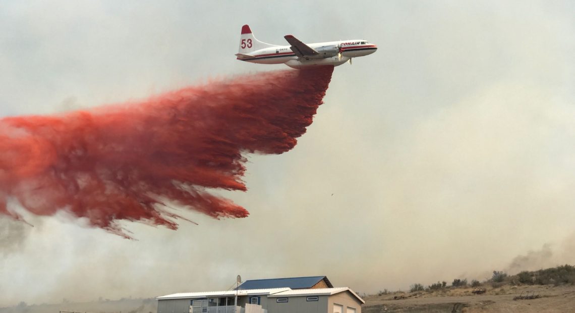 A plane drops fire retardant near a home Sept. 2, 2020, during the Evans Canyon Fire burning in Yakima and Kittitas counties. Courtesy of Tony Miller