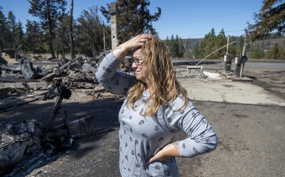 Hollie Jordan surveys her father's service station that was destroyed by a wildfire on Tuesday, Sept. 8, 2020, in Malden, Wash. "This was filled with work and life and memories and it's all gone," Jordan said. CREDIT: Jed Conklin/AP