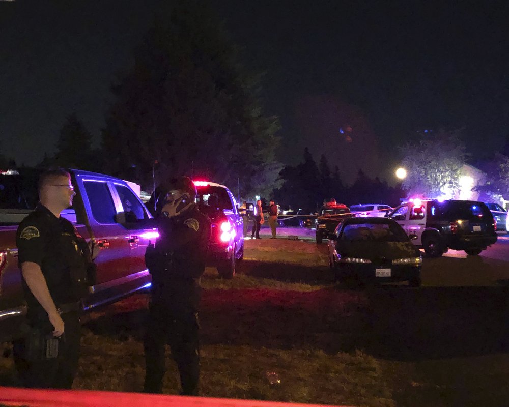 Police officials work at a scene where Michael Reinoehl, suspected of fatally shooting a supporter of a right-wing group in Portland, Oregon, last week was killed as investigators moved in to arrest him in Lacey, Wash., on Sept. 3, 2020. CREDIT: Ted Warren/AP