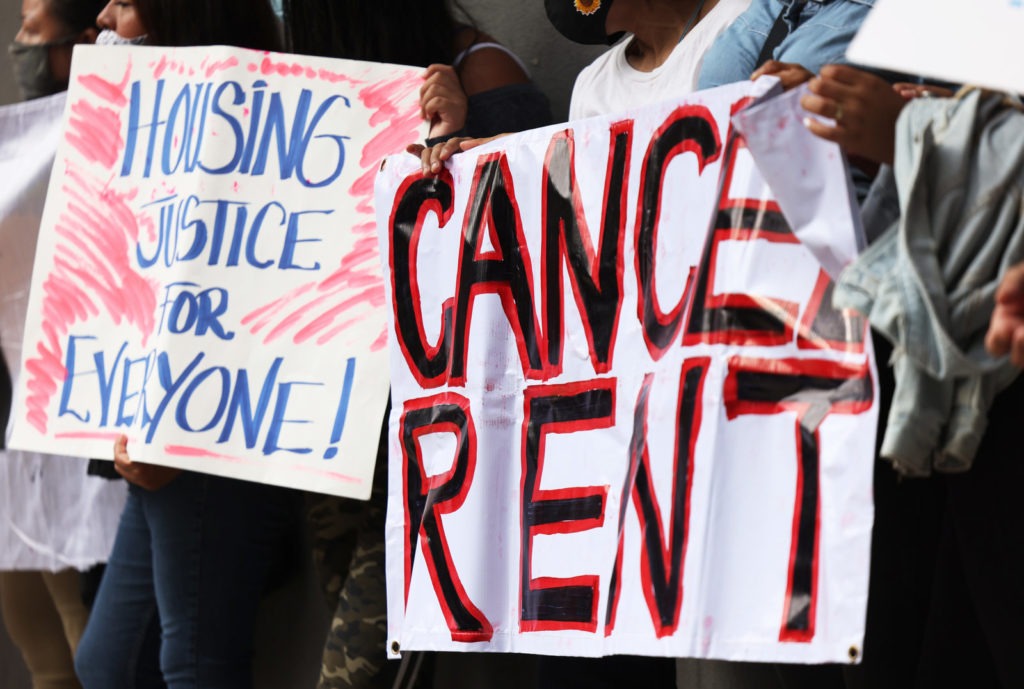 Demonstrators hold up signs as they gather at Brooklyn Housing court during a 'No Evictions, No Police' national day of action in New York City. CREDIT: Michael M. Santiago/Getty Images