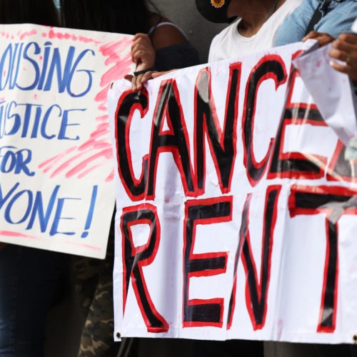 Demonstrators hold up signs as they gather at Brooklyn Housing court during a 'No Evictions, No Police' national day of action in New York City. CREDIT: Michael M. Santiago/Getty Images