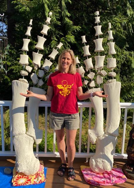 Stefanie Worwag poses with the reassembled flippers of a previously beached gray whale that washed ashore near Port Townsend in 2019. CREDIT Mario Rivera