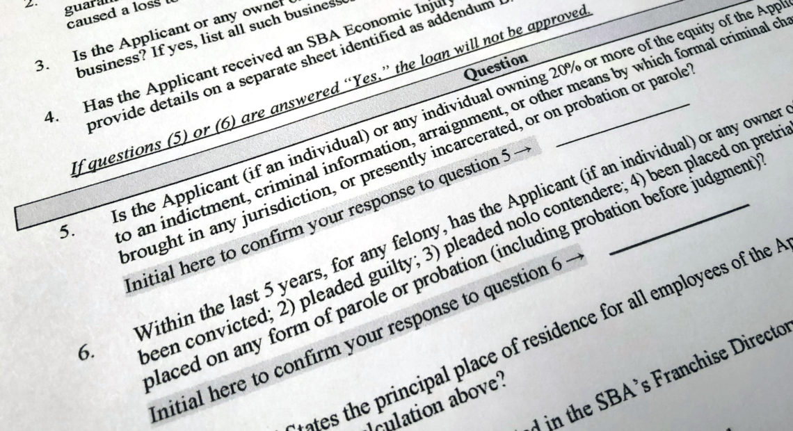 The Justice Department has accused 57 people of defrauding the Paycheck Protection Program. A portion of the program's application is shown here. CREDIT: Wayne Partlow/AP