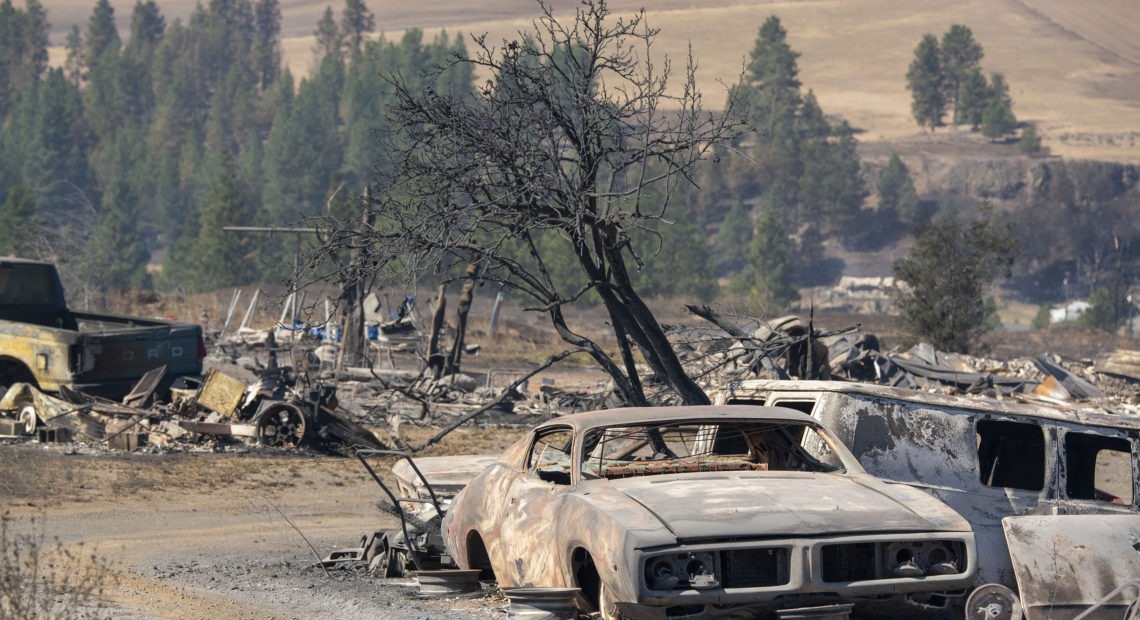 Vehicles were destroyed by a wildfire in Malden, Wash., on Monday, Sept. 7, 2020. Large parts of the West Coast are under warnings for elevated fire weather threats Thursday, but there may be relief if fire-driving winds decrease as expected. CREDIT: Jed Conklin/AP