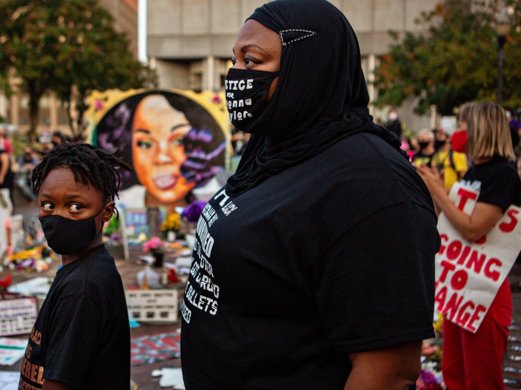 The grand jury recording in the Breonna Taylor case will be released, after a judge ordered the attorney general's office to produce the recording by Wednesday. Here, a mother and son attend a demonstration in what activists are now calling Injustice Square Park in downtown Louisville, as protesters demand justice for Taylor's killing by police. Jason Armond/Los Angeles Times via Getty Images