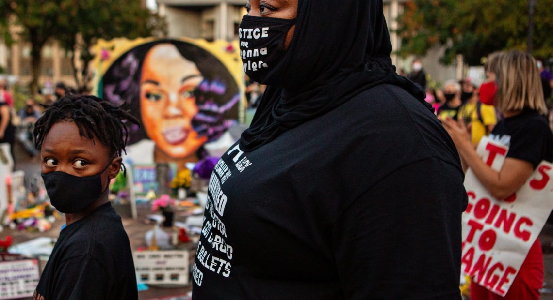 The grand jury recording in the Breonna Taylor case will be released, after a judge ordered the attorney general's office to produce the recording by Wednesday. Here, a mother and son attend a demonstration in what activists are now calling Injustice Square Park in downtown Louisville, as protesters demand justice for Taylor's killing by police. Jason Armond/Los Angeles Times via Getty Images