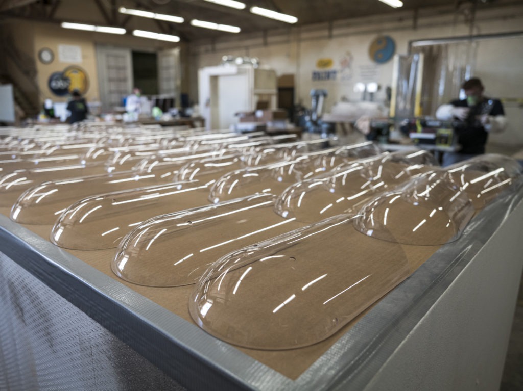 Plastic face shields sit on a table at Mask & Shield, a division of Monster City Studios, in Fresno, Calif., on May 27. CREDIT: David Paul Morris/Bloomberg via Getty Images