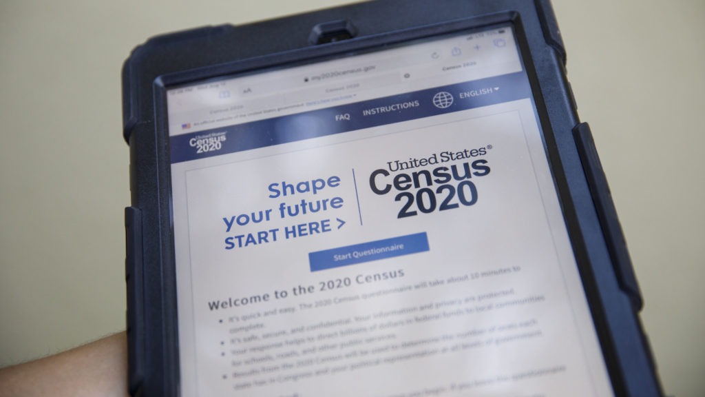 A volunteer in Los Angeles holds a computer tablet displaying the online questionnaire for the 2020 census in August. CREDIT: Patrick T. Fallon/Bloomberg via Getty Images