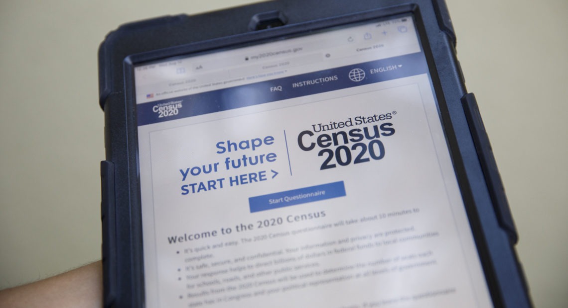 A volunteer in Los Angeles holds a computer tablet displaying the online questionnaire for the 2020 census in August. CREDIT: Patrick T. Fallon/Bloomberg via Getty Images