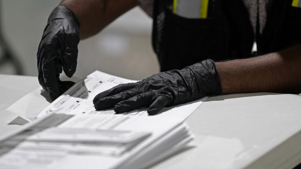 A worker prepares absentee ballots for mailing at the Wake County Board of Elections in Raleigh, N.C., earlier this month. Gerry Broome/AP