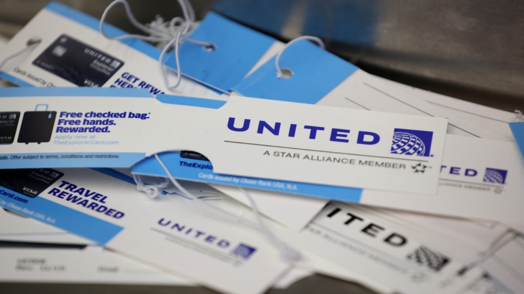 United Airlines baggage tags are displayed on a table at San Francisco International Airport. The carrier says it's starting a pilot program next month that will offer rapid coronavirus testing at the airport or via a self-collected, mail-in test ahead of a flight. Justin Sullivan/Getty Images