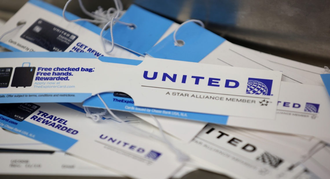 United Airlines baggage tags are displayed on a table at San Francisco International Airport. The carrier says it's starting a pilot program next month that will offer rapid coronavirus testing at the airport or via a self-collected, mail-in test ahead of a flight. Justin Sullivan/Getty Images