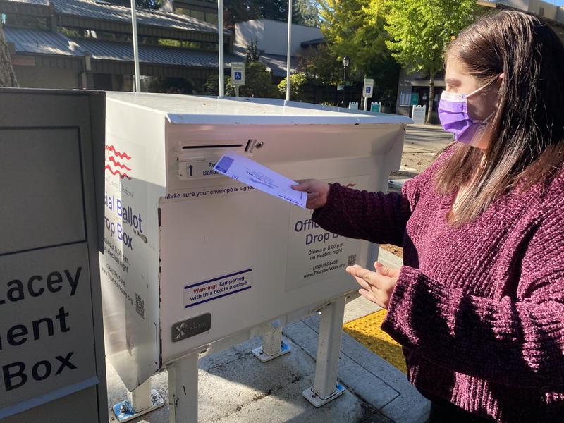 drops her ballot in a drop box at Lacey City Hall in Thurston County on Monday, Oct. 26. CREDIT: Austin Jenkins/N3