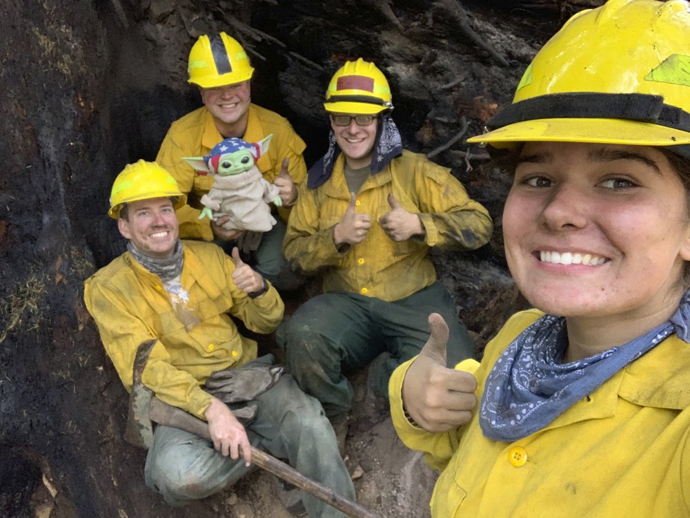 Lucas Galloway, from left, Jaebyn Drake, Rhett Schieder and Audrey Wilcox pose for a selfie with Baby Yoda on Sept. 20, 2020, while fighting the Holiday Farm Fire in Blue River, Oregon. In early September, a 5-year-old Oregon boy named Carver and his grandmother delivered a toy version of “The Mandalorian” character to a donation center for firefighters. Courtesy of Audrey Wilcox via AP