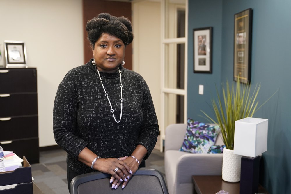 Lisa Rice, President and CEO of the National Fair Housing Alliance, in her office, Oct. 28, 2020, in Washington, D.C. Several fair housing organizations accused Redfin of systematic racial discrimination in a lawsuit filed Oct. 29, saying the online real estate broker offers fewer services to homebuyers and sellers in minority communities – a type of “digital redlining” that has depressed home values and exacerbated historic injustice in the housing market. CREDIT: Patrick Semansky/AP