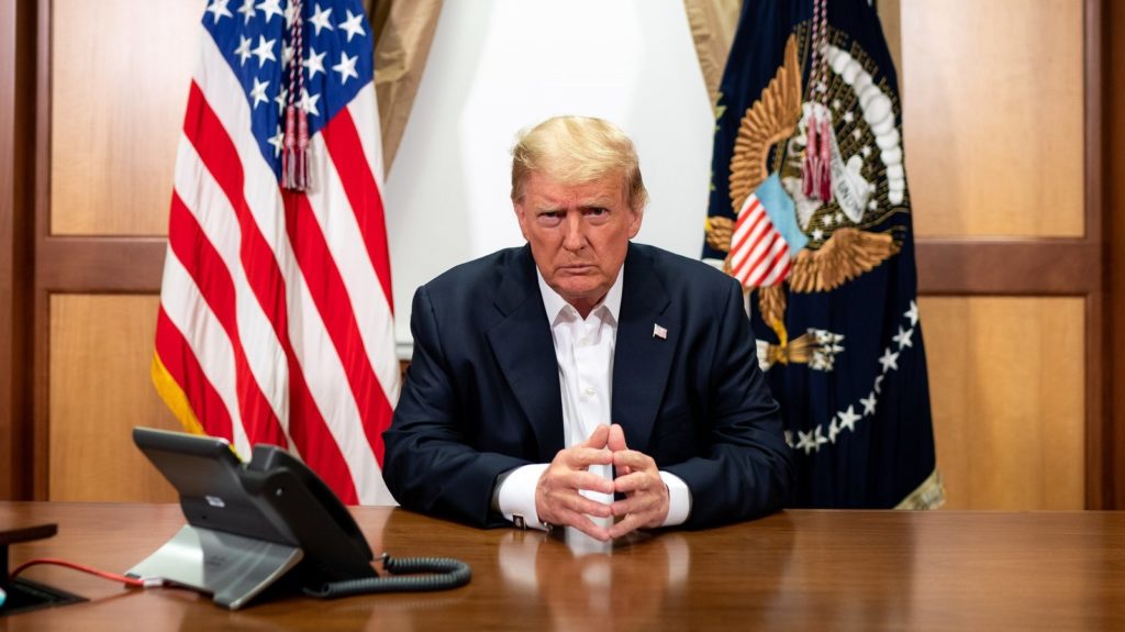 President Trump participates in a conference call Sunday at Walter Reed National Military Medical Center. Tia Dufour/The White House via Getty Images