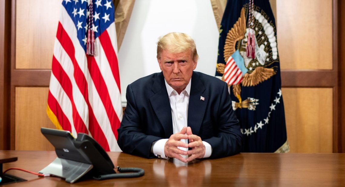 President Trump participates in a conference call Sunday at Walter Reed National Military Medical Center. Tia Dufour/The White House via Getty Images