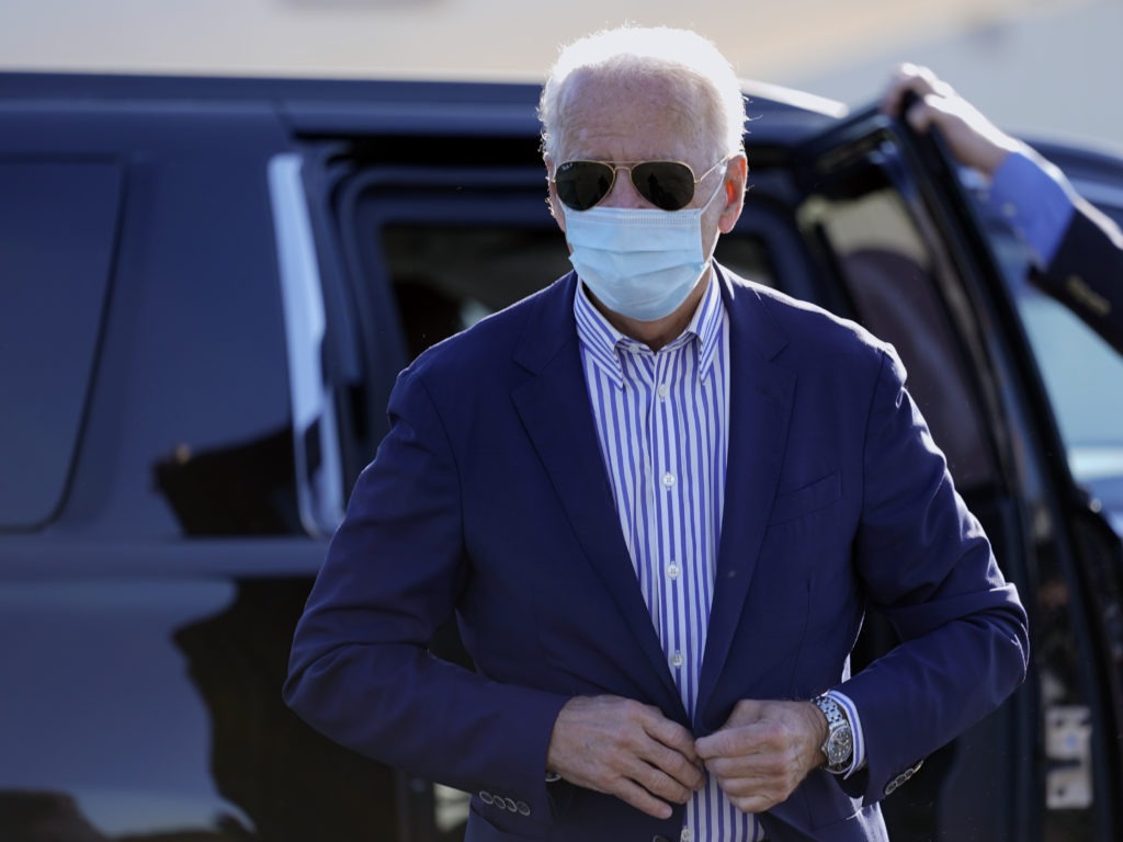 Democratic presidential candidate Joe Biden walks to board his campaign plane in New Castle, Del., earlier in October 2020. CREDIT: Carolyn Kaster/AP