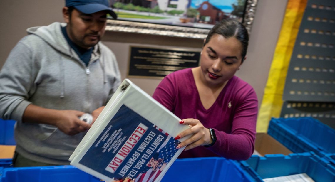 Jonathan Lucero and Valeria Gutierrez prepare to receive ballots at the El Paso County Courthouse during the presidential primary in March. Paul Ratje/AFP via Getty Images